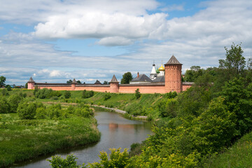 Naklejka premium View of the Spaso-Evfimiev Monastery (a monastery of the Vladimir Diocese of the Russian Orthodox Church) on the bank of the Kamenka River on a sunny summer day, Suzdal, Vladimir region, Russia