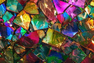 Colorful rainbow broken glass, mica slices on the mosaic wall. Abstract textured background