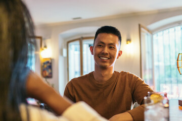 Portrait of a smiling asian man in a bar
