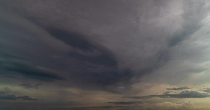 Timelapse dark storm clouds dramatic black sky background. Dark clouds before thunderstorm coming. Meteorology danger windstorm climate. Dark cloudscape storm disaster timelapse gloomy gray sky.
