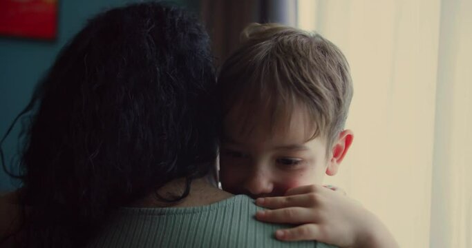 Cute preschool son kisses mom. Happy little boy hugging his mother at home. Loving mum and kid cuddling embrace cheerful to family holiday event.Concept love mom.