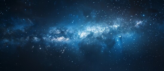 Obraz premium Dark blue sky filled with twinkling stars and a milky-like structure resembling a cosmic cloud
