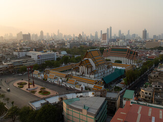 An aerial view of Red Giant Swing and Suthat Thepwararam Temple at sunrise scene, The most famous tourist attraction in Bangkok, Thailand.