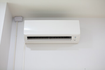 White air conditioner installed in a white room.