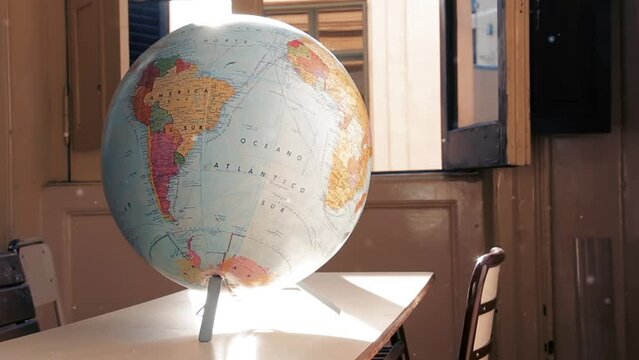 Close Up of an Old Earth Globe Showing South America on a Wooden Desk Indoors