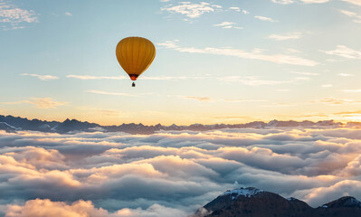 hot air balloon floating above the clouds at sunset