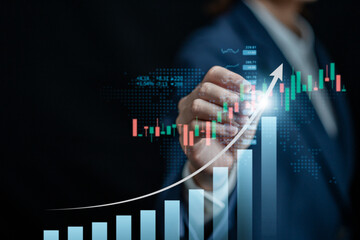 Businesswomen analyze the stock market with a digital virtual chart,  trend upside business market...