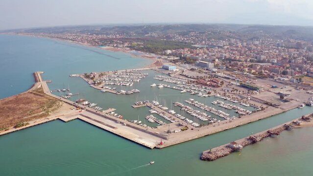 4k drone flight moving to the side footage (Ultra High Definition) of Pescara port. Beautiful morning seascape of Adriatic sea. Incredible outdoor scene of Italy, Europe. Traveling concept background.