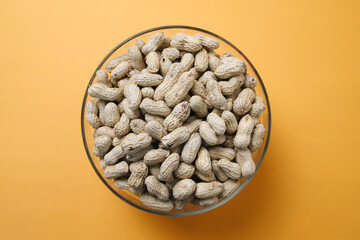 A Bowl Of Dry Peanuts Isolated on Yellow Background 