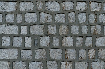 Background, texture of a stone wall with decorative seams from a thick layer of cement mortar