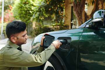 Indian electric car owner charging his vehicle