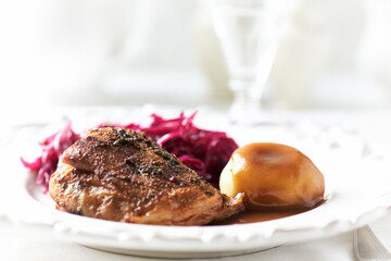 Fried pork ribs with potato dumplings on bright background. Close up.	