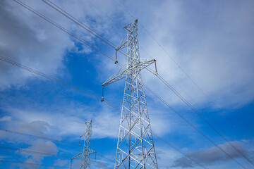 High voltage post. High voltage tower on blue sky background.