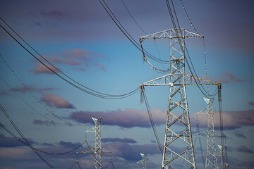 High voltage post. High voltage tower on blue sky background.