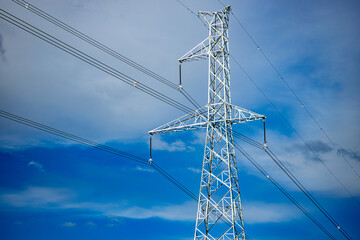 High voltage post. High voltage tower on blue sky background.
