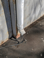 An old empty drainpipe on a spring day