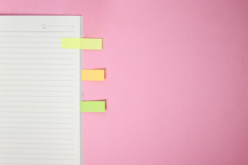 Page Marker Sticky Notes Sandwiched Between Books Isolated on Pink Background 