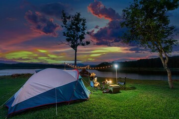 Tourists enjoying camping by lake