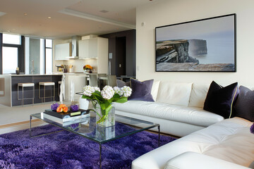 a beautiful purple and white living room with three vertical art prints on the wall, sofa in cream colour with red flowers inside it, glass coffee table in front of couch