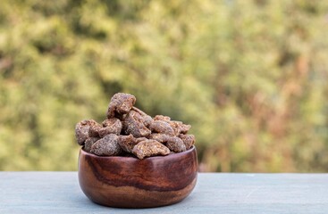 Amla Candy or Indian Gooseberry Candy in a Wooden Bowl Isolated on Wooden Table with Copy Space, Also Known as Emblica Myrobalan or Phyllanthus Emblica