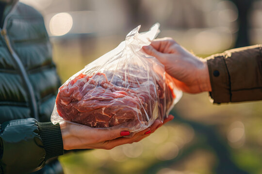 Close up view of giving of sacrificial meat on Eid al-Adha on the street