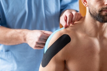 Elastic therapeutic tape application on the shoulder for support and rehabilitation. - 791320408