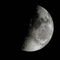 First quarter moon phase isolated on black background. 

