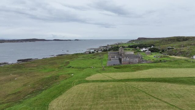 Aerial View of Iona Abbey and Nunnery Ancient Landmark and Homes on Island Coastline, Scotland UK