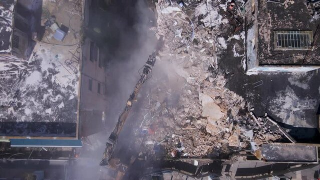 Top shot of Bulldozer clears the rubble of collapsed buildings in the on David Bloch street, Tel Aviv, Israel