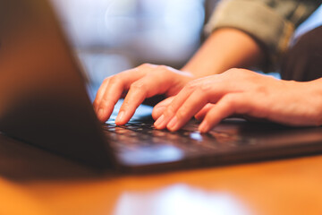 Closeup image of a woman working and typing on laptop computer keyboard - 791325249