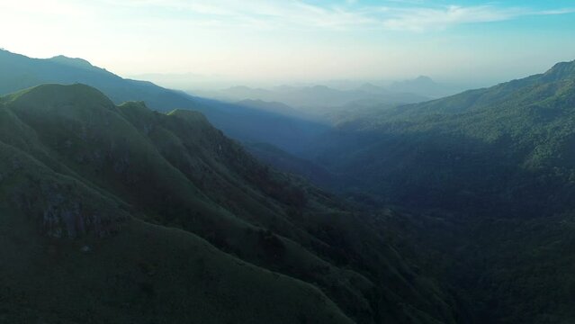 Aerial drone landscape view of scenic mountain range rolling hills with early morning nature sunrise vegetation Ella Sri Lanka Asia travel tourism