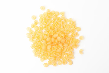 Shell shaped pasta on white background. Uncooked, dry conchiglie macaroni. Top view