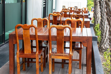 Wooden chairs and tables in a street cafe - 791327462