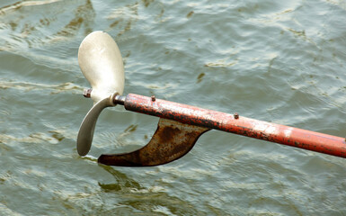 Metal propeller from a boat against the background of water