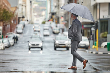 Walking, city and business man with umbrella for morning commute, travel and journey to workplace...