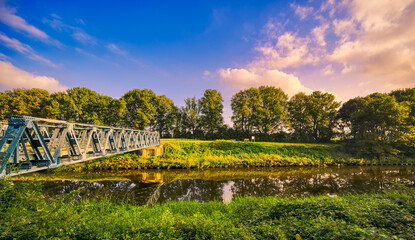 Laarbrug bridge spanning the Wilhelminakanaal canal near the village of Aarle-Rixtel, The Netherlands. Featuring blue sky and some sunset lit clouds.