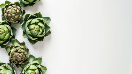 Fototapeta premium Artichokes on white background with copy space, top view