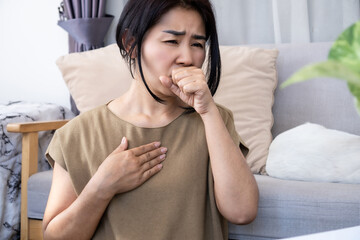 Asian woman suffering from chronic coughing caused by heartburn from acid reflux