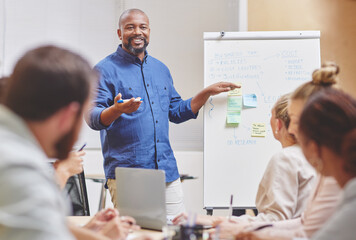 Black man, coaching and team with whiteboard for presentation, meeting or planning at office. Happy...