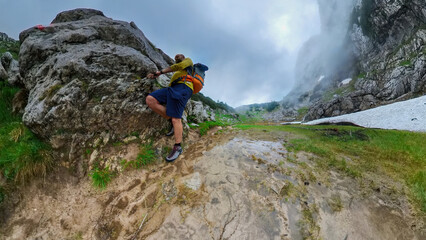 Man with backpack on a lonely hike tour though the Berchtesgaden mountains