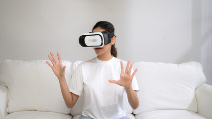 Young woman using virtual reality VR goggle at home for vivancy online shopping experience. The virtual reality VR innovation optimized for female digital entertainment lifestyle.