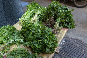 Different fresh aromatic herbs, mint, coriander on outdoor stall. Medina souk, Fez Morocco
