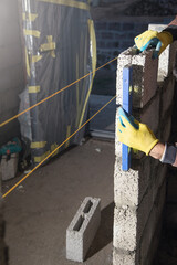 Worker builds a wall in the building site. - 791336239