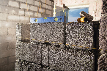 Measure level on brick wall in construction site. - 791336244