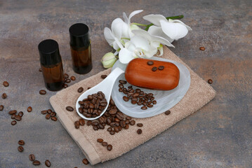 Personal care products with caffeine, hair shampoo, soap and towel with coffee beans.