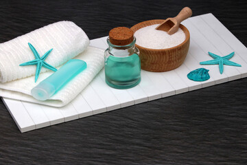 Sea salt concept of natural skin care. Sea salt in wooden bowl and essential oils.