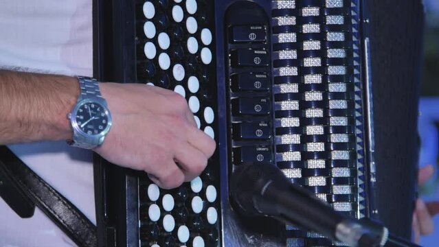 A man plays the accordion at a celebration.