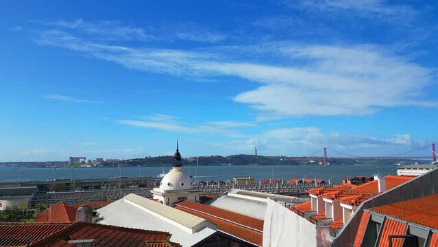 Going up between buildings towards the Cais do Sodre train station with the Tagus River in the background,Lisbon,Portugal