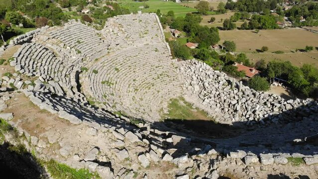 View from drone of ruins of Roman amphitheater at archaeological site of ancient city of Selge and picturesque surroundings on spring day, Altinkaya, Turkey