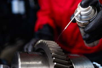 Close up view transmission oil being sprayed on gears.